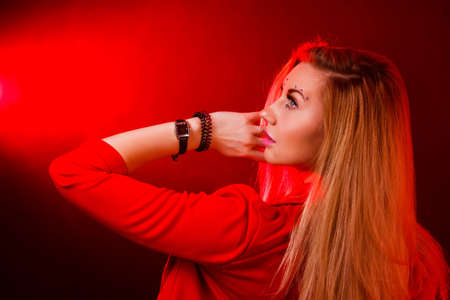 Beautiful young woman in bright red lights