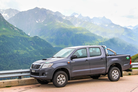 GOTTHARD PASS, SWITZERLAND - AUGUST 5, 2014: Motor car Toyota Hilux at the high Alpine mountain road.のeditorial素材