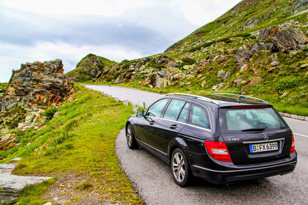 TYROL, AUSTRIA - JULY 29, 2014: Black estate car Mercedes-Benz W204 C180 at the Grossglockner High Alpine road.のeditorial素材