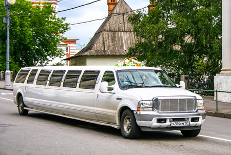 MOSCOW, RUSSIA - JULY 9, 2011: White limousine Ford Excursion at the city street.のeditorial素材
