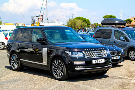 SAINT-TROPEZ, FRANCE - AUGUST 3, 2014: Black luxury car Range Rover at the city street.のeditorial素材