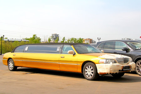 MOSCOW, RUSSIA - MAY 5, 2012: Golden limousine Lincoln Town Car at the city street.のeditorial素材