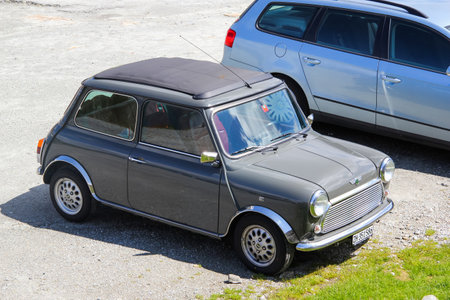GOTTHARD PASS, SWITZERLAND - AUGUST 5, 2014: Classic British compact car Austin Mini Cooper at the high mountain Alpine road.のeditorial素材