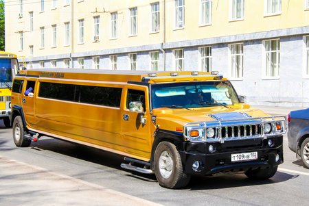 UFA, RUSSIA - MAY 25, 2012: Golden limousine Hummer H2  at the city street.のeditorial素材