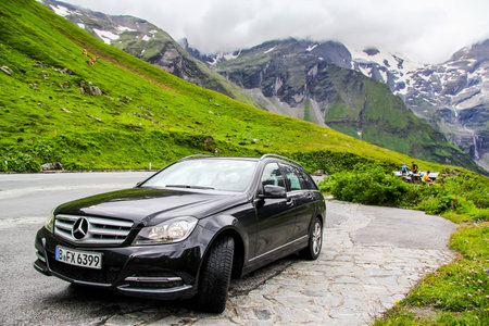 TYROL, AUSTRIA - JULY 29, 2014: Black estate car Mercedes-Benz W204 C180 at the Grossglockner High Alpine road.のeditorial素材