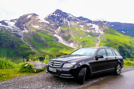 TYROL, AUSTRIA - JULY 29, 2014: Black estate car Mercedes-Benz W204 C180 at the Grossglockner High Alpine road.のeditorial素材