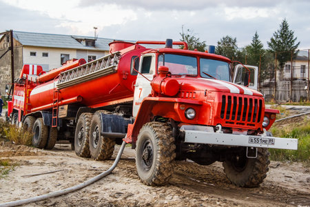 NOVYY URENGOY, RUSSIA - AUGUST 3, 2015: Red fire cistern Ural 44202 takes part in the extinguishing...
