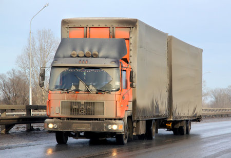 BASHKORTOSTAN, RUSSIA - MARCH 11, 2015: Very dirty cargo truck MAN M90 at the interurban road.のeditorial素材