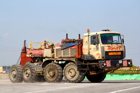 NOVYY URENGOY, RUSSIA - JULY 22, 2013: MZKT Volat heavy semi-trailer truck at the interurban road.のeditorial素材
