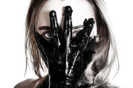 Young woman holding a tarred hand on her face