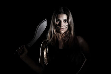 Woman with a huge knife in the darknessの写真素材