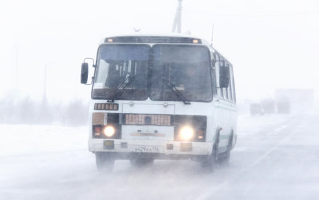 NOVYY URENGOY, RUSSIA - OCTOBER 20, 2013: Suburban bus PAZ 3205 at the interurban freeway during a heavy blizzard.のeditorial素材