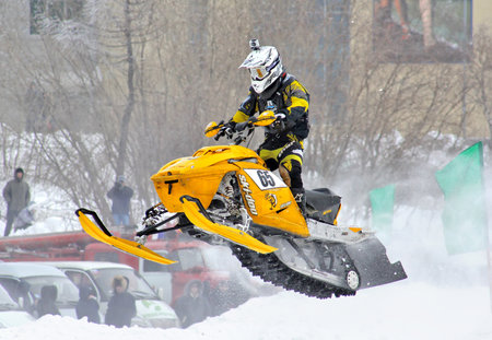 NOVYY URENGOY, RUSSIA - APRIL 6: Undefined competitor's BRP Ski-Doo Snowmobile No. 65 competes at the annual Russia Snowcross Championship on April 6, 2013 in Novyy Urengoy, Russia.のeditorial素材