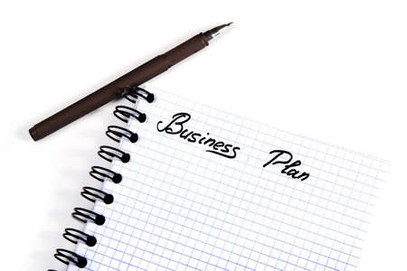 Notepad with a business plan isolated on white backgroundの写真素材