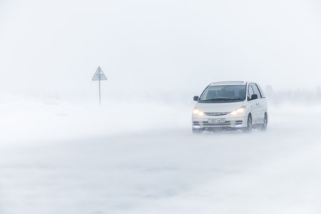 NOVYY URENGOY, RUSSIA - MARCH 20, 2016: Family van Toyota Previa at the interurban freeway during a heavy northern blizzard.のeditorial素材
