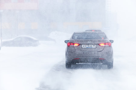 NOVYY URENGOY, RUSSIA - MARCH 20, 2016: Motor car Hyundai Elantra at the city street during a heavy northern blizzard.のeditorial素材