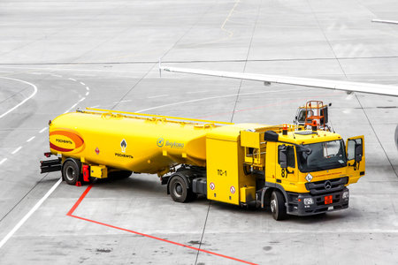 MOSCOW, RUSSIA - SEPTEMBER 9, 2013: Yellow fuel tank truck Mercedes-Benz Actros at the air field of the Vnukovo international airport.のeditorial素材