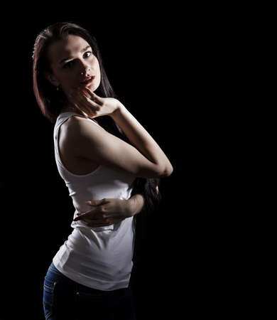 Portrait of a beautiful young woman over black background