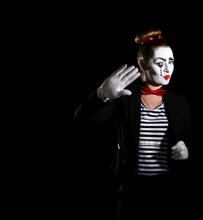 Female mime artist over black backgroundの写真素材
