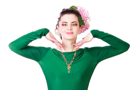 Beautiful young woman in a green evening dress isolated over white backgroundの写真素材
