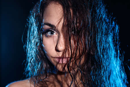 Pretty young woman with a wet blue hairの写真素材