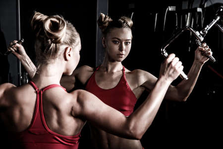 Beautiful young woman in a gymの写真素材