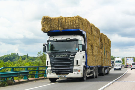 RHONE-ALPES, FRANCE - AUGUST 7, 2014: White hay carrier Scania R500 at the interurban freeway.のeditorial素材
