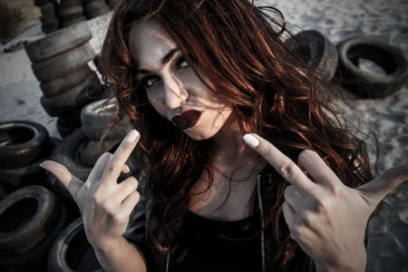 Disheveled redhead woman showing a fuck signsの写真素材