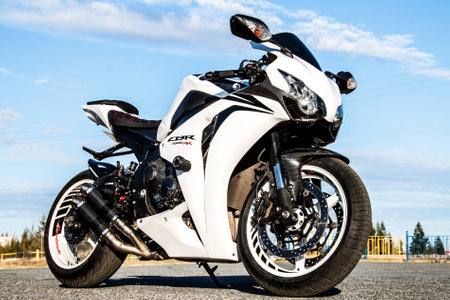 NOVYY URENGOY, RUSSIA - AUGUST 21, 2016: White bike Honda CBR-1000RR parked at the countryside. NOVYY URENGOY, RUSSIA - AUGUST 21, 2016: White bike Honda CBR-1000RR parked at the countryside.