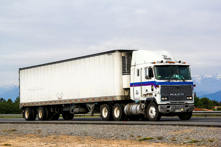 O'HIGGINS, CHILE - NOVEMBER 19, 2015: Semi-trailer truck Mack MH at the interurban freeway.のeditorial素材