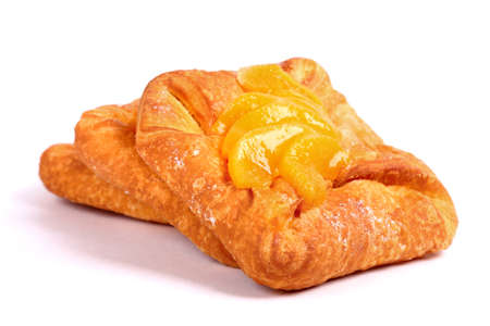 Fresh buns covered with mandarin slices isolated over white backgroundの写真素材