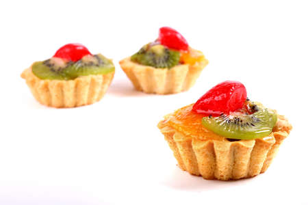 Sweet desserts with a kiwi, orange fruit and strawberry isolated over white background