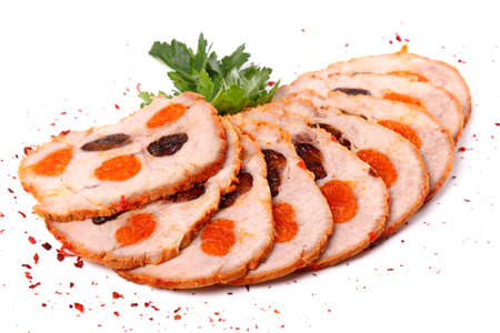 Sliced meat filled with dried apricots and raisin isolated over white backgroundの写真素材