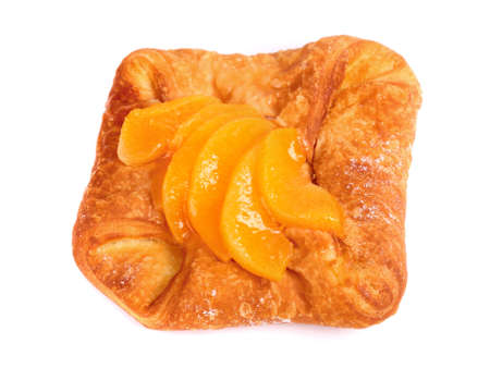 Fresh bun covered with mandarin slices isolated over white backgroundの写真素材