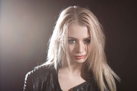 Portrait of a pretty young girl over black background