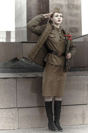 Pretty young girl in a Soviet military uniform