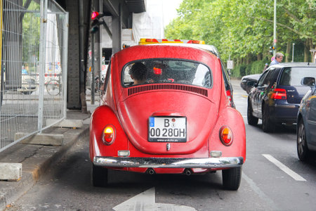 BERLIN, GERMANY - AUGUST 15, 2014: Red classic vintage car Volkswagen Beetle in the city street.のeditorial素材