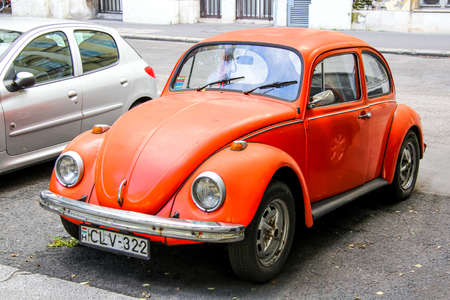 BUDAPEST, HUNGARY - JULY 23, 2014: Red classic vintage car Volkswagen Beetle in the city street.のeditorial素材