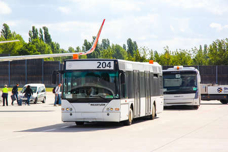 BERLIN, GERMANY - AUGUST 19, 2014: White airport bus Neoplan N4416 Centroliner at the air field of the Tegel International Airport.のeditorial素材