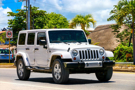 TULUM, MEXICO - MAY 17, 2017: Motor car Jeep Wrangler in the city street.のeditorial素材