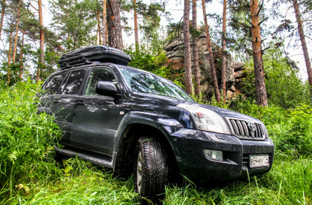 CHELYABINSK REGION, RUSSIA - JULY 8, 2017: Black off-road car Toyota Land Cruiser Prado 120 at the...