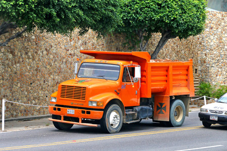 Acapulco, Mexico - May 31, 2017: Orange dump truck Dina S-500 in the city street.のeditorial素材