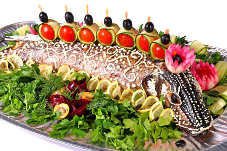 Baked pike served with vegetables isolated over white backgroundの写真素材