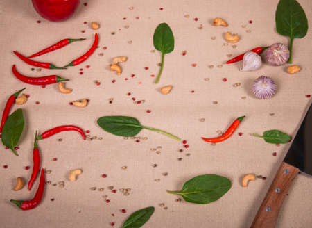 Background of the chili pepper, cashew nuts and green leavesの写真素材