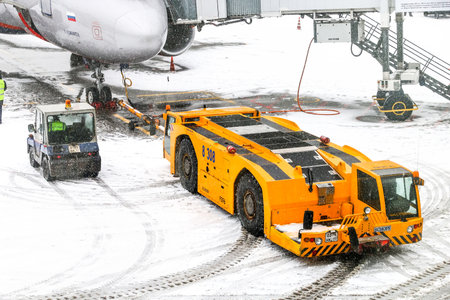 Moscow, Russia - February 3, 2018: Conventional tow tractor Schopf F396 in the Sheremetyevo International Airport during a heavy snowfall.のeditorial素材