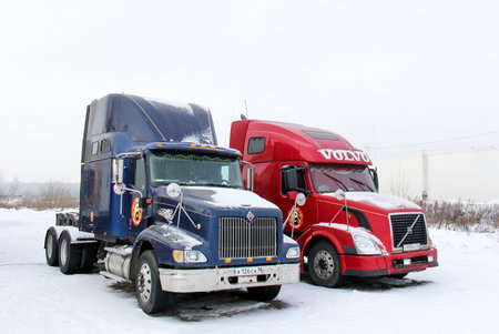 Ufa, Russia - February 3, 2018: American semi-trailer trucks International 9200i and Volvo VNL64T in the city street.のeditorial素材