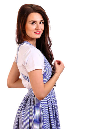 Young woman in a striped dress isolated over white backgroundの写真素材