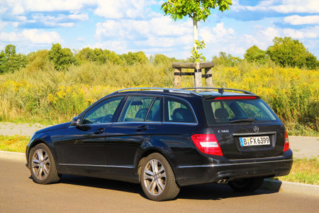 Berlin, Germany - August 12, 2014: Motor car Mercedes-Benz W204 C180 at the countryside.