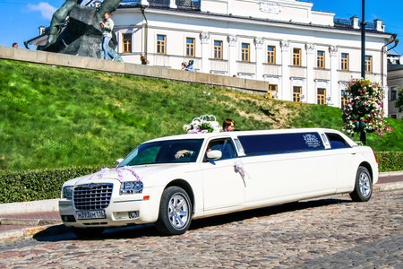 Kazan, Russia - August 21, 2010: White limousine Chrysler 300C in the city street.のeditorial素材