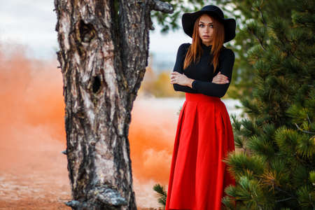 Young woman in a red skirt in a fairy forestの写真素材